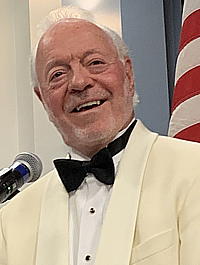 Smiling man in a tux.