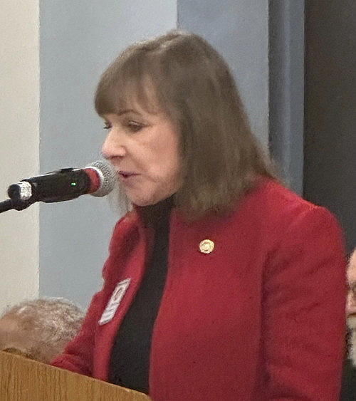 Woman at microphone.