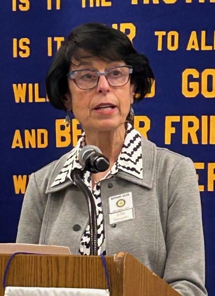 Woman speaking into microphone.