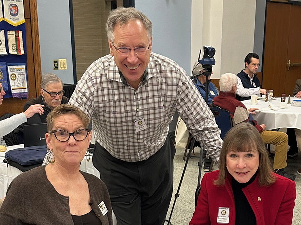 Three people smiling.