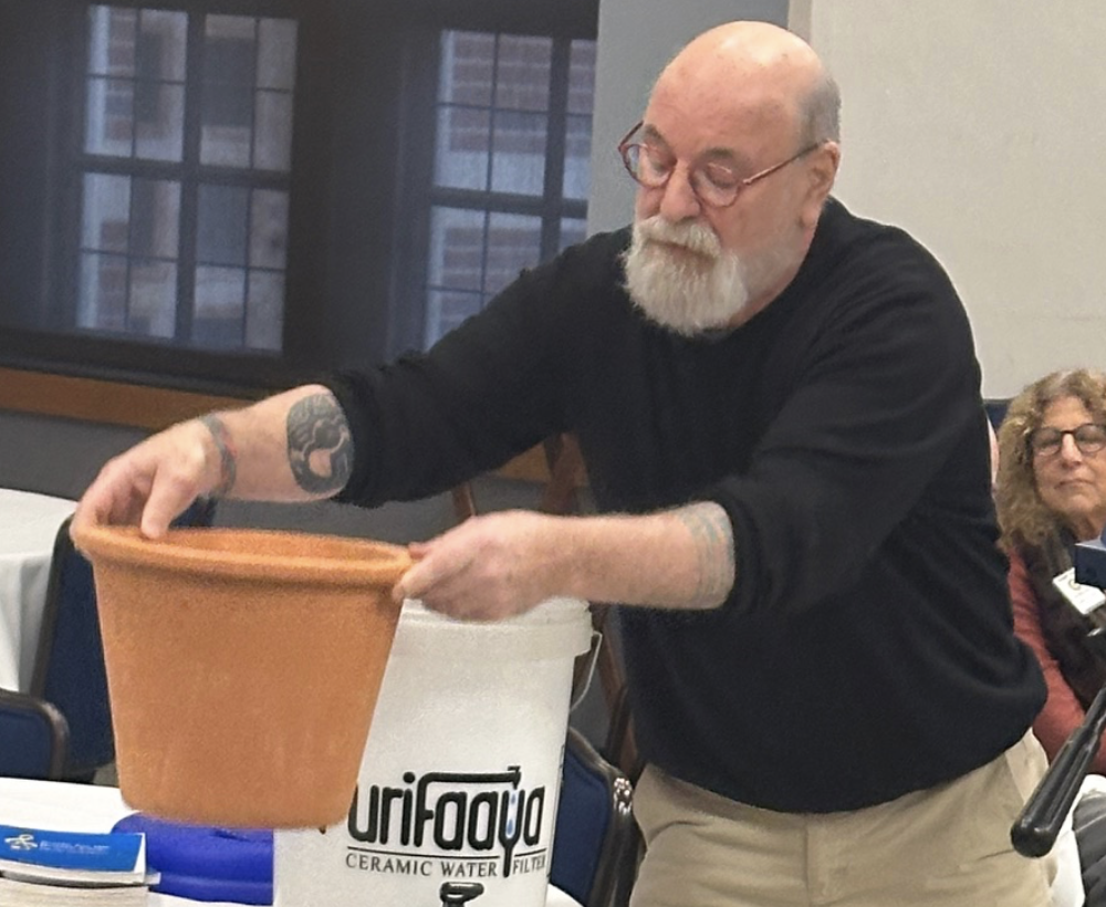 Man holding ceramic pot.