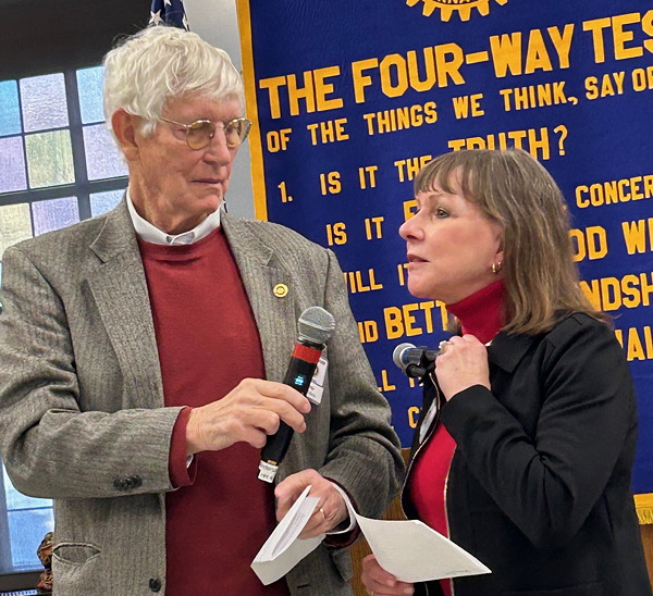 A man and a woman speaking to one another.