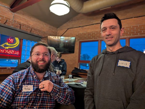Two young men smiling.