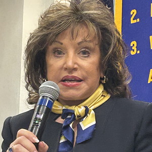 Woman speaking into microphone.