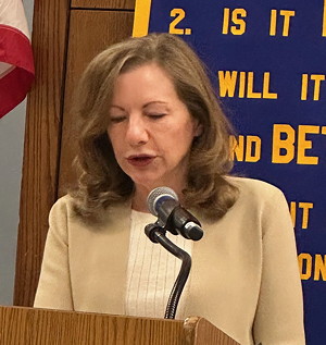 Woman at microphone.