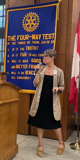 Woman standing by podium.