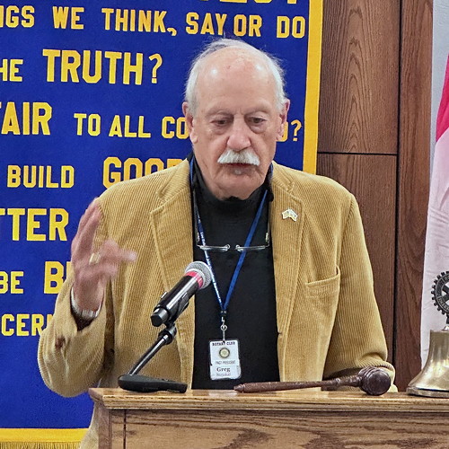 Mann speaking at a. podium.
