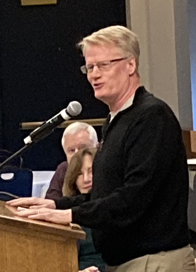 Man speaking at podium.