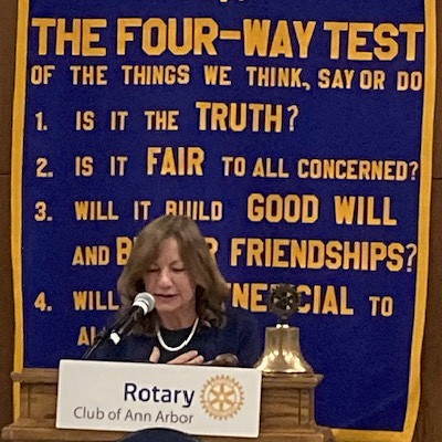 Woman speaking at podium.