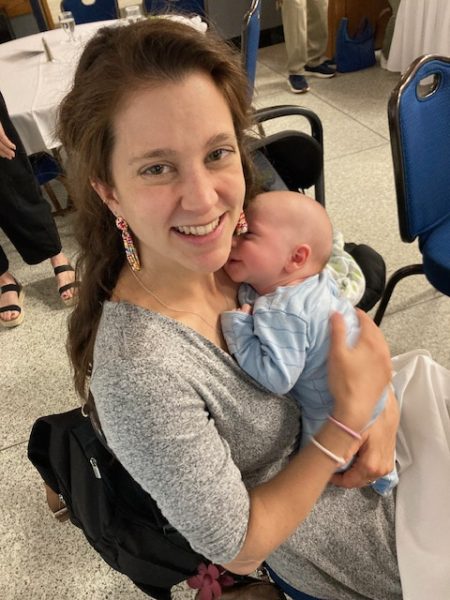 Young woman holding newborn.